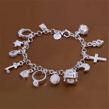 Silver tone crystal charm bracelet featuring thirteen various pendants and charms.