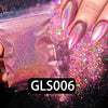 A hand holds a glitter nail polish product with pink holographic rainbow shimmer dust scattered around it.