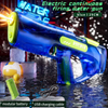 Blue electric continuous firing water gun with a green nozzle and modular battery on a dark surface.