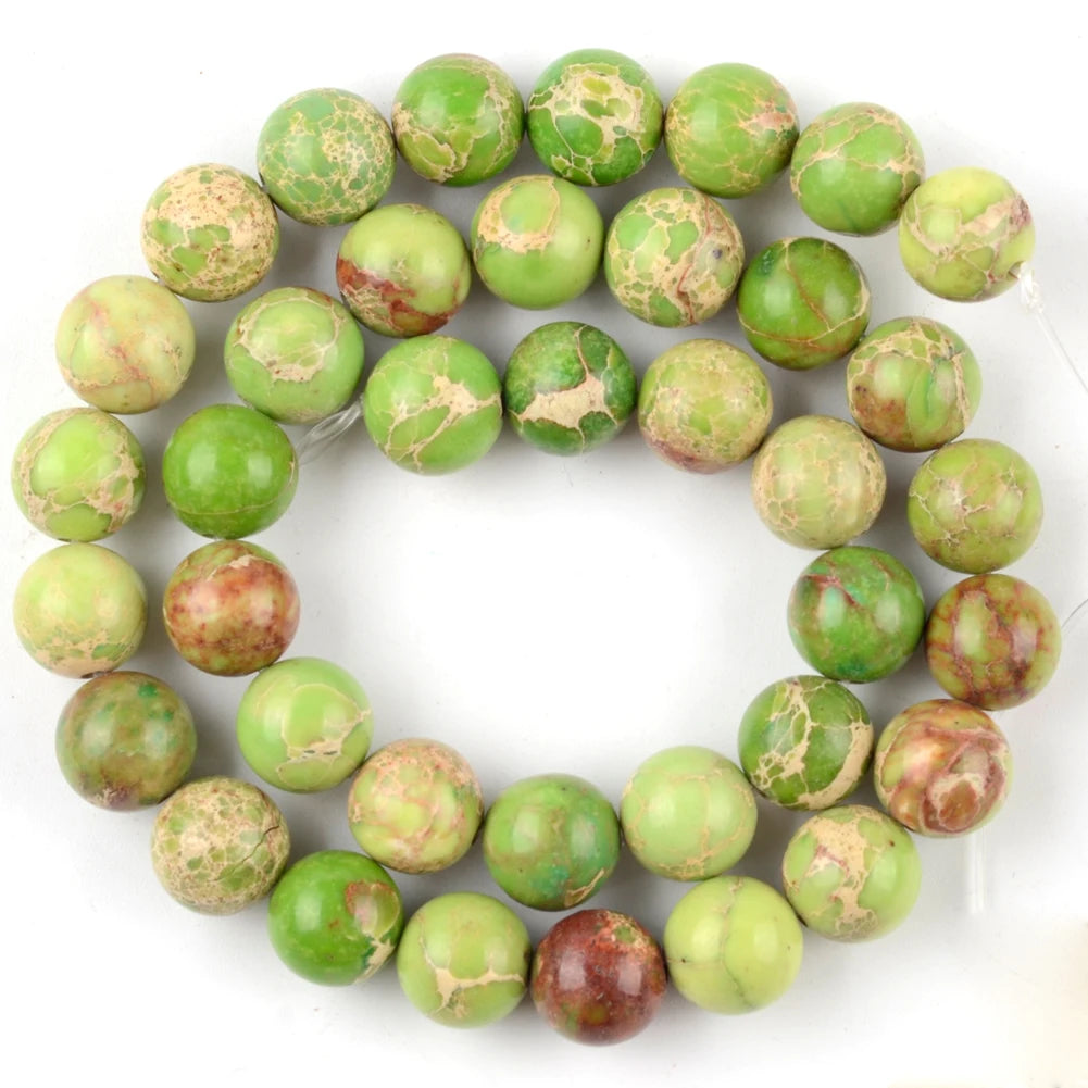 A circular arrangement of natural sea sediment jasper and turquoise beads for jewelry making