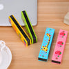A set of colorful wooden harmonica products featuring cartoon animal designs in yellow, green, and pink.