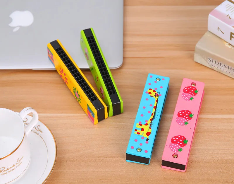 A set of colorful wooden harmonica products featuring cartoon animal designs in yellow, green, and pink.