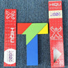 A wooden tangram puzzle featuring geometric shapes in red, green, and blue colors.