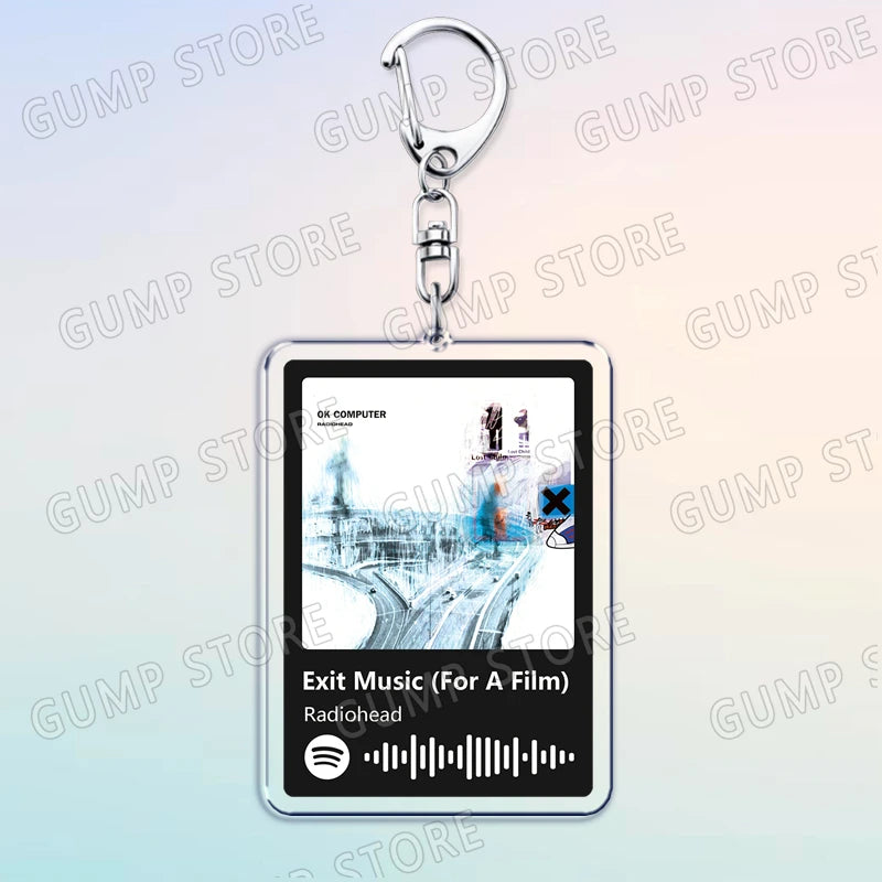 Silver acrylic keychain featuring a graphic of a music player interface labeled Exit Music For A Film