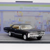 A black 1967 Chevrolet Impala diecast model car with a chrome grille and brightwork, displayed on a gray surface.