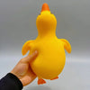 A hand is holding a bright yellow, squishy duck fidget toy against a light gray background.