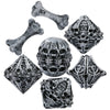 A set of carved bone skull polyhedral dice showing various angles and facets.