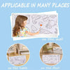 A roll of sticky coloring paper is shown applied on a wall, a table, and the floor.