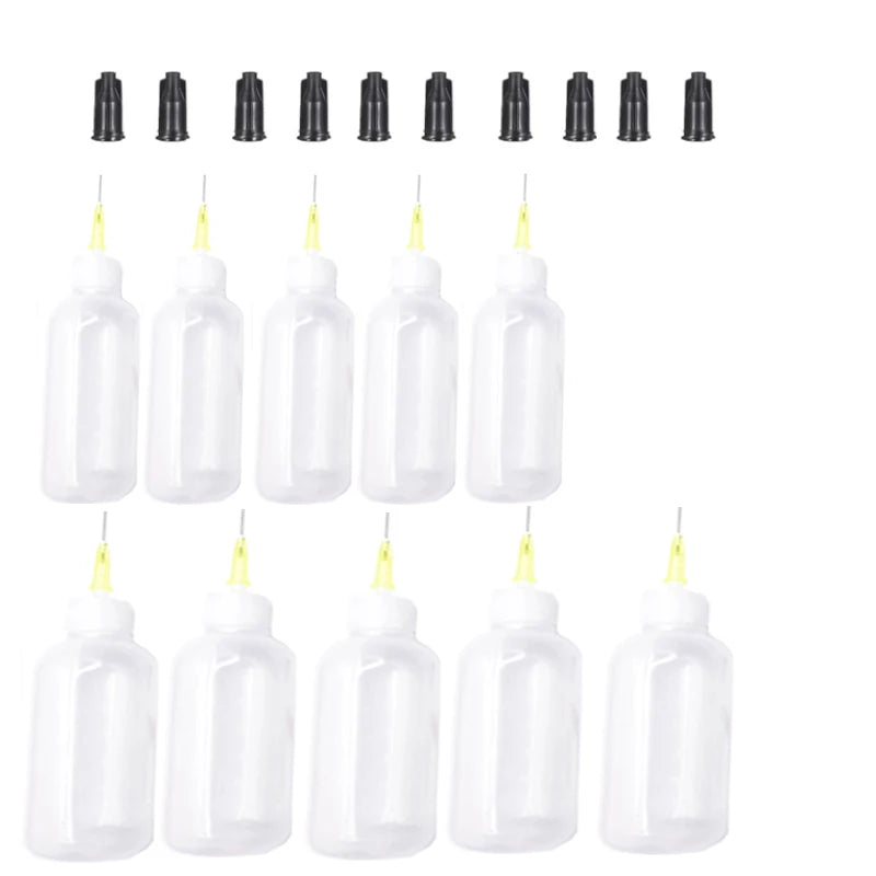 A collection of clear plastic squeeze bottles with blunt needle tips for precision dispensing.