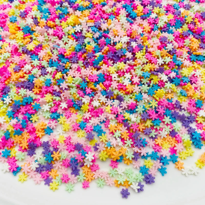 A pile of colorful polymer clay star and heart sprinkles in various bright colors like pink, blue, yellow, and purple.
