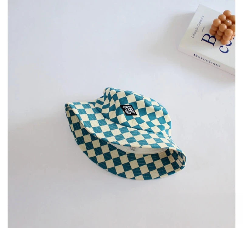 A teal and white checkered bucket hat is shown against a white background.