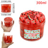 A jar of watermelon slime with fruit pieces and a sliced watermelon garnish, showing the texture and volume.