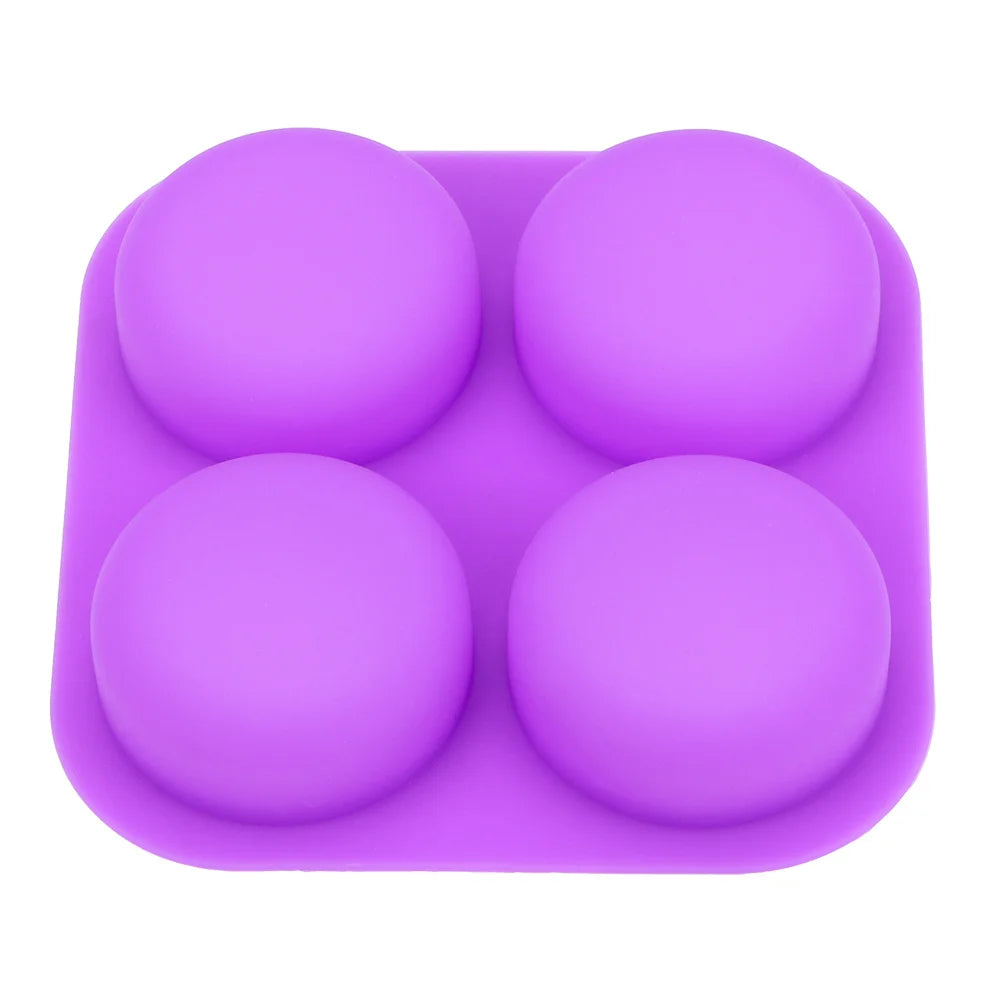 A purple silicone mold with four hemispherical cavities for soap making or DIY crafts.