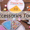 Assortment of metal O-ring spring clasps and various jewelry making tools displayed on a wooden surface.