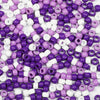A pile of multicolor pony beads in purple and white, including various shapes like round and tube beads.