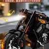 A close-up shot of a black motorcycle model with orange accents, highlighting its lights and engine details.