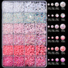 A grid of pink and white AB resin rhinestones and pearls in various sizes for DIY crafts