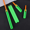 Three bright green and orange 3D printed butterfly knife fidget toys lying on a black surface.