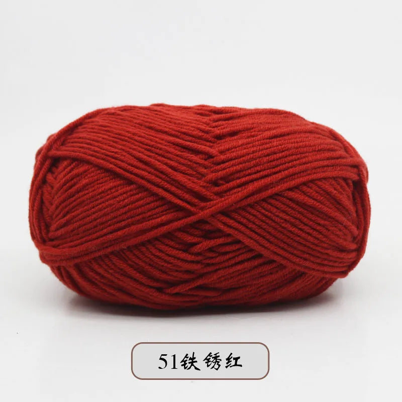 A ball of pre-dyed milk cotton yarn in a reddish-orange color, wound into a thick skein.