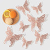 Rose gold 3D butterfly wall stickers arranged with a slice of lemon and an orange.