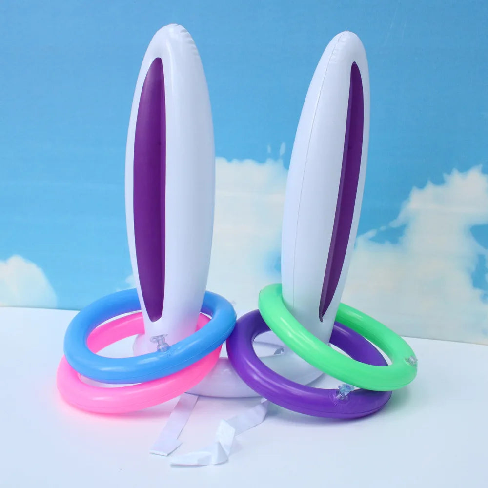 A set of purple and white plastic Easter egg and spoon race game pieces with colored rings on a white surface.