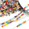 Multicolor faceted glass bicone crystal beads for jewelry making displayed on a white background.