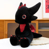 A black Toothless Dragon plush toy sitting on a white surface.