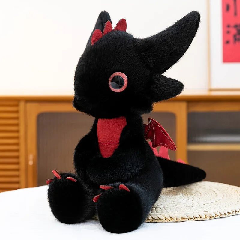 A black Toothless Dragon plush toy sitting on a white surface.