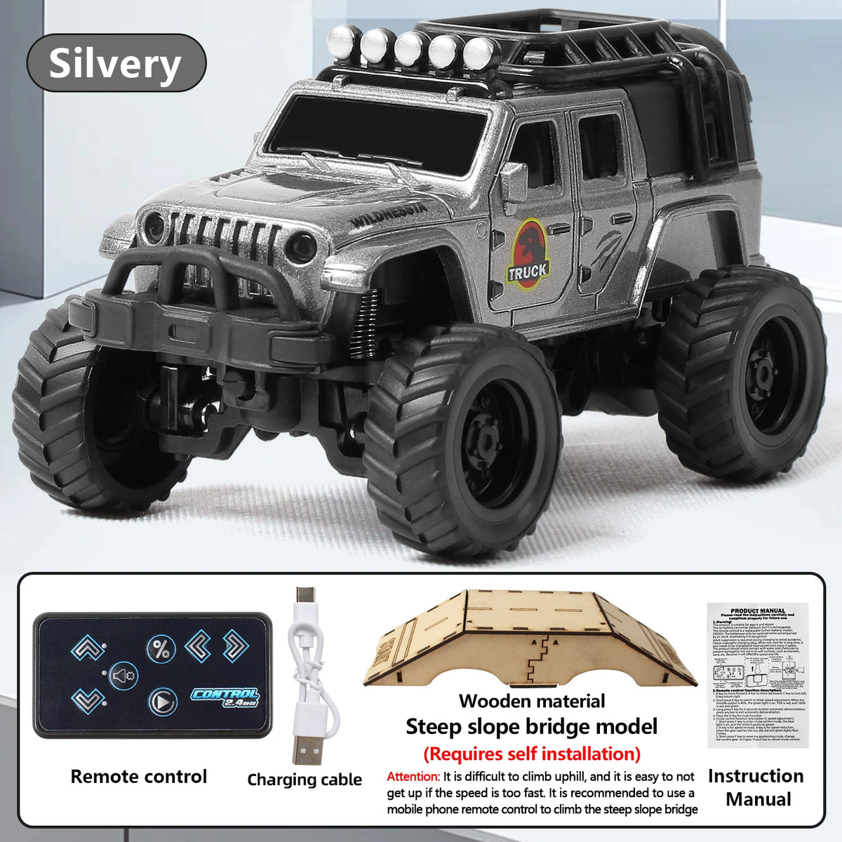 A silver off-road RC truck model with large tires and a black body shell is shown next to its remote control and instruction 