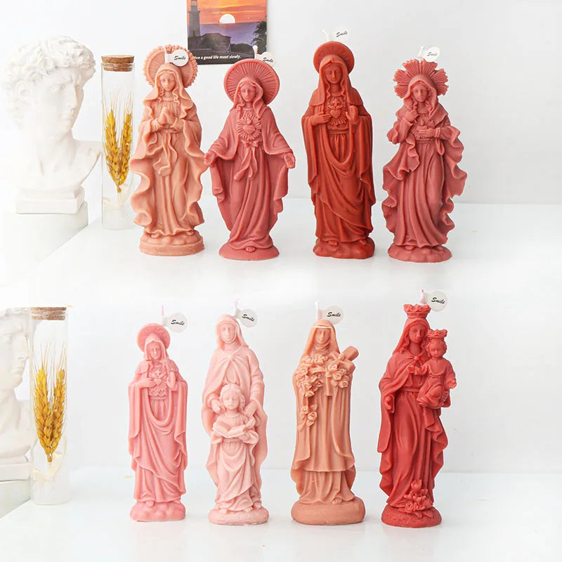 A collection of terracotta-colored silicone figure molds depicting religious figures for crafting.