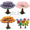 A set of building blocks depicting three trees with pink, purple, and orange blossoms.