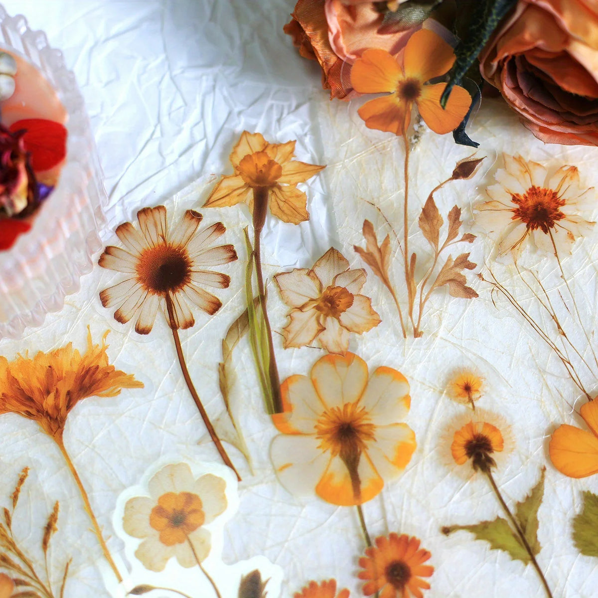 A collection of 50 transparent orange and yellow floral PET stickers for journals and crafts