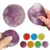 A collection of purple and multicolored soft squeeze sensory stress relief fidget balls shown in various sizes and hands.