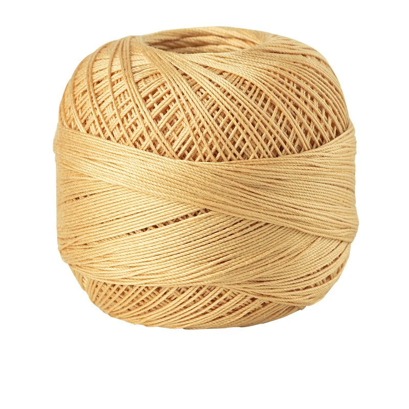 A ball of natural beige cotton crochet thread used for tatting and embroidery.