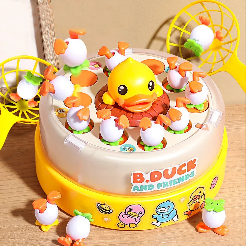 A round cake decorated with yellow and white figures, surrounded by yellow plastic fans.