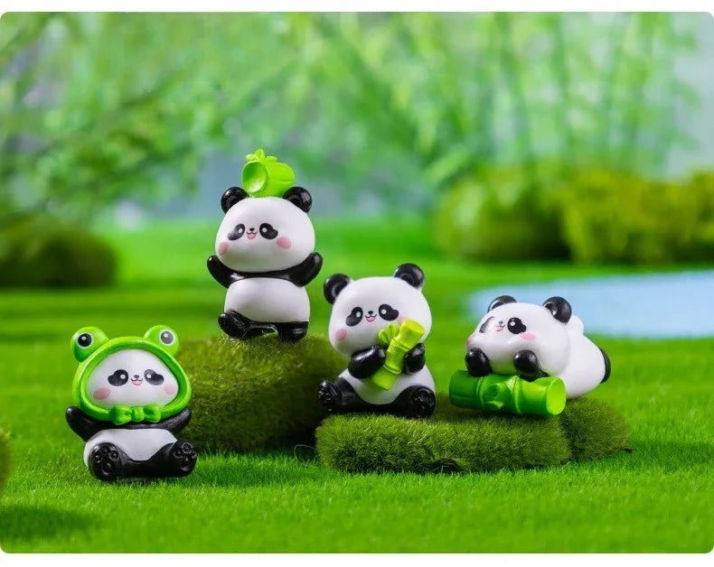 A set of adorable resin panda figurines in various poses and colors sitting on green grass.