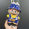 Labubu doll wearing a blue plaid hat and yellow overalls outfit