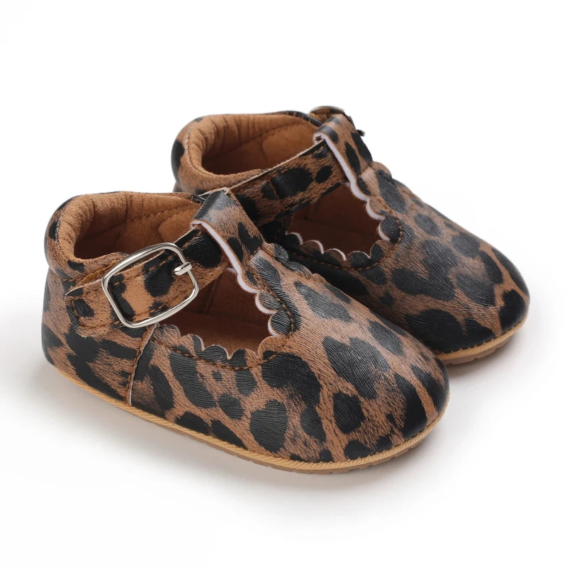 A pair of leopard print soft sole baby sneakers shown from the side.
