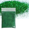 A bag of green holographic fine glitter powder next to a pile of green glitter.