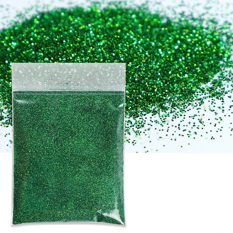 A bag of green holographic fine glitter powder next to a pile of green glitter.