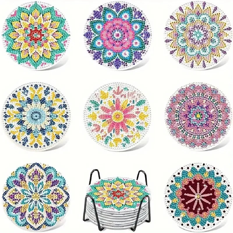 A collection of eight colorful diamond art coasters with holders in various floral and geometric patterns.