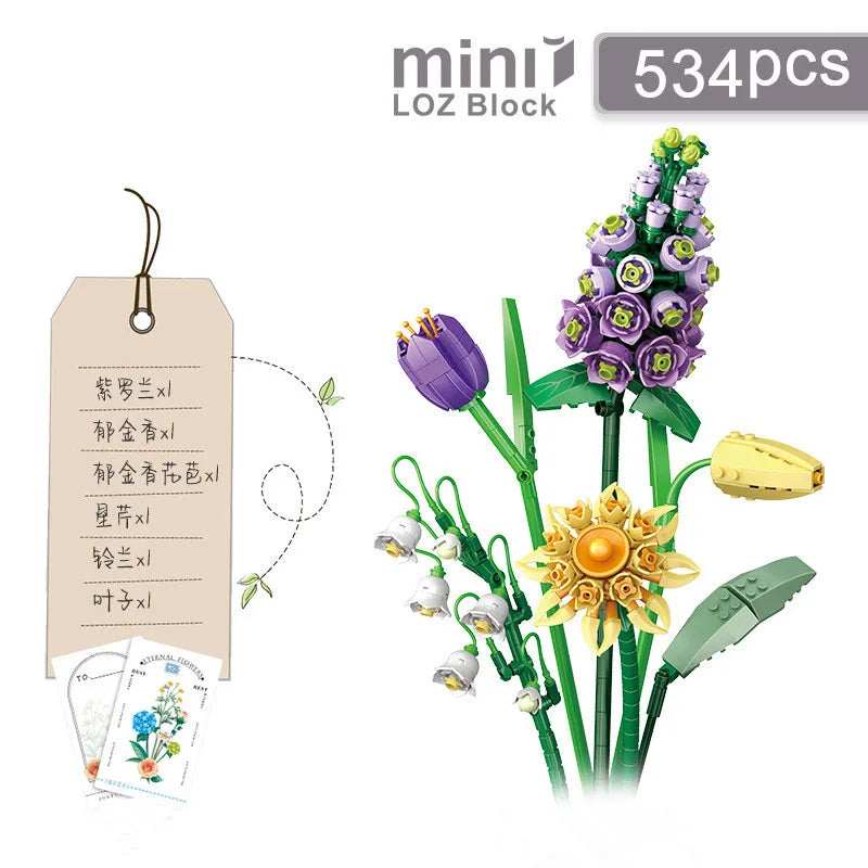 A set of 534 mini blocks used to build a floral bouquet display featuring purple and yellow flowers on green stems.