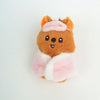 An adorable brown cartoon animal plush with pink ears and a pink and white fluffy garment.