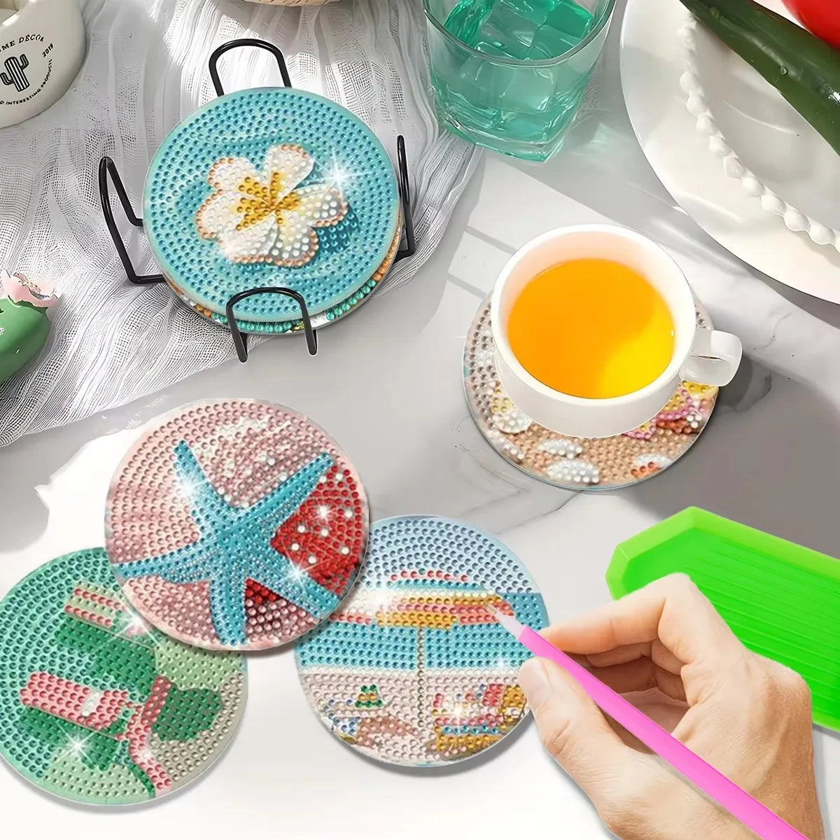 A collection of DIY diamond painting coasters in various colors and designs are displayed on a white surface.
