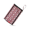 A pink and maroon patterned storage bag for a portable 2-in-1 baby changing mat.