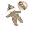 A beige knit romper outfit for a reborn doll, shown with a matching hood and a doll wearing the outfit.