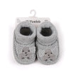 Pair of grey knitted baby booties featuring a cute bunny design