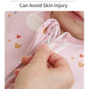 A hand is adjusting the neck flap design on a pink baby sleeping bag to prevent skin injury.
