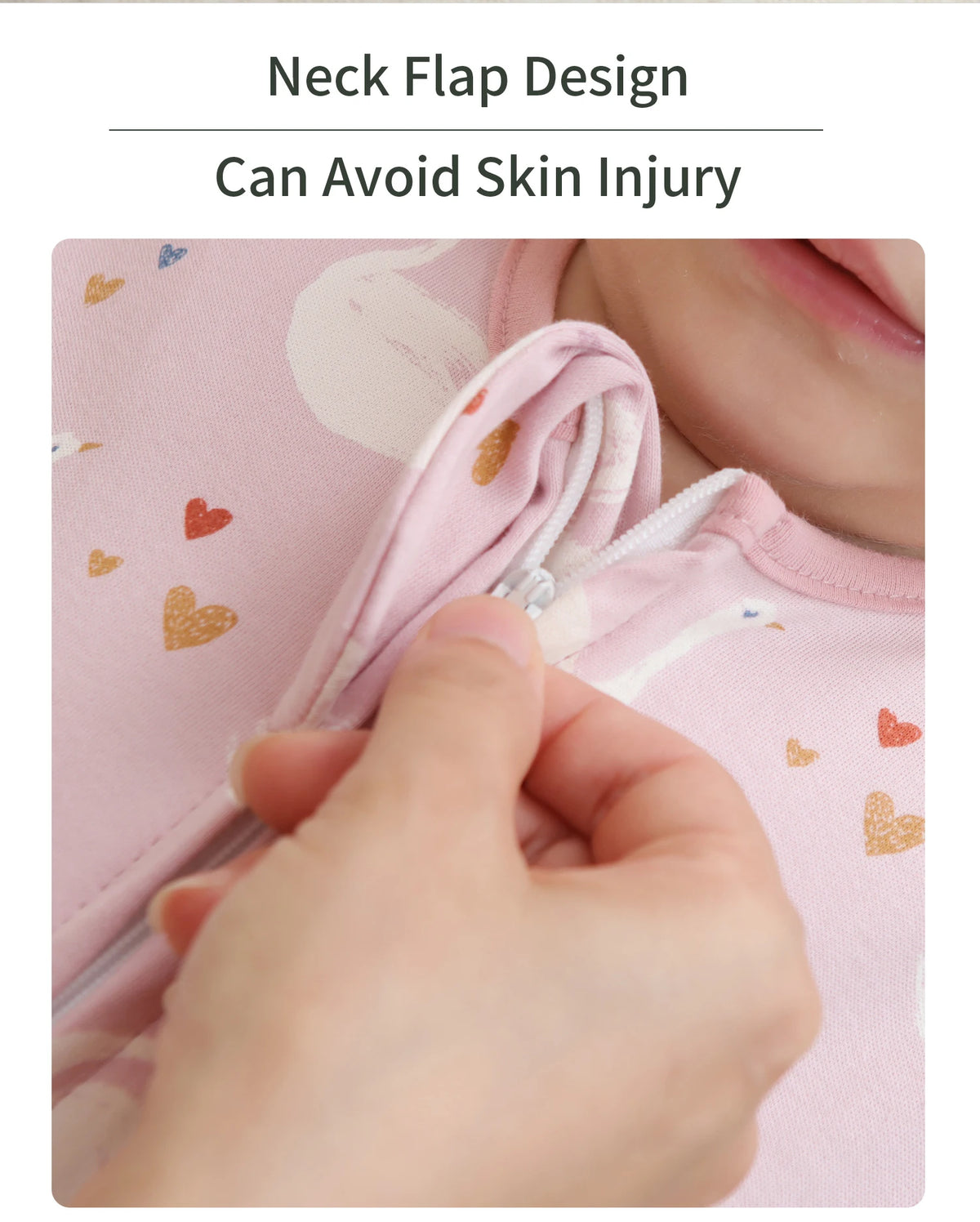 A hand is adjusting the neck flap design on a pink baby sleeping bag to prevent skin injury.