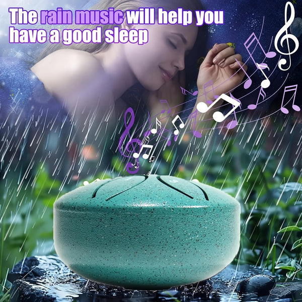 A person is sleeping while rain music plays, near a teal-colored steel tongue drum.